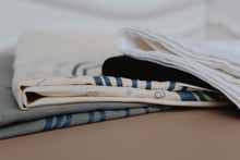 Load image into Gallery viewer, Selection of shucking tea towels sold by Richard Haward's Oysters