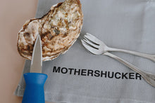 Load image into Gallery viewer, Oyster with a knife, fork, and napkin with 'MOTHERSHUCKER' text on a neutral background
