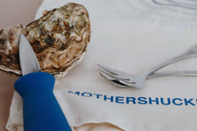 Load image into Gallery viewer, Oyster with a knife on a plate with 'MOTHERSHUCK' text