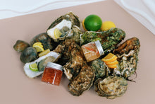 Load image into Gallery viewer, Mersea and Jersey Oysters on a plate with lemon wedges and shallot vinegar dressing. 
